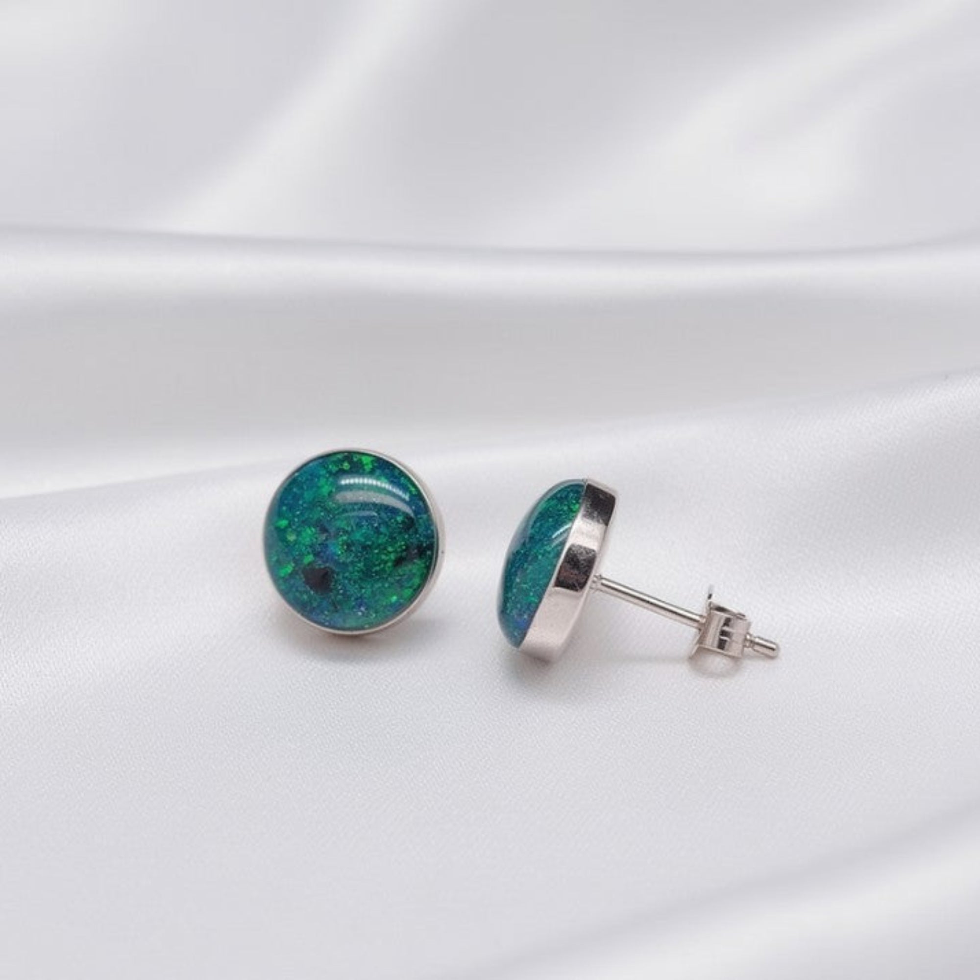 Silver Opal Studded Earrings on Silk White Background