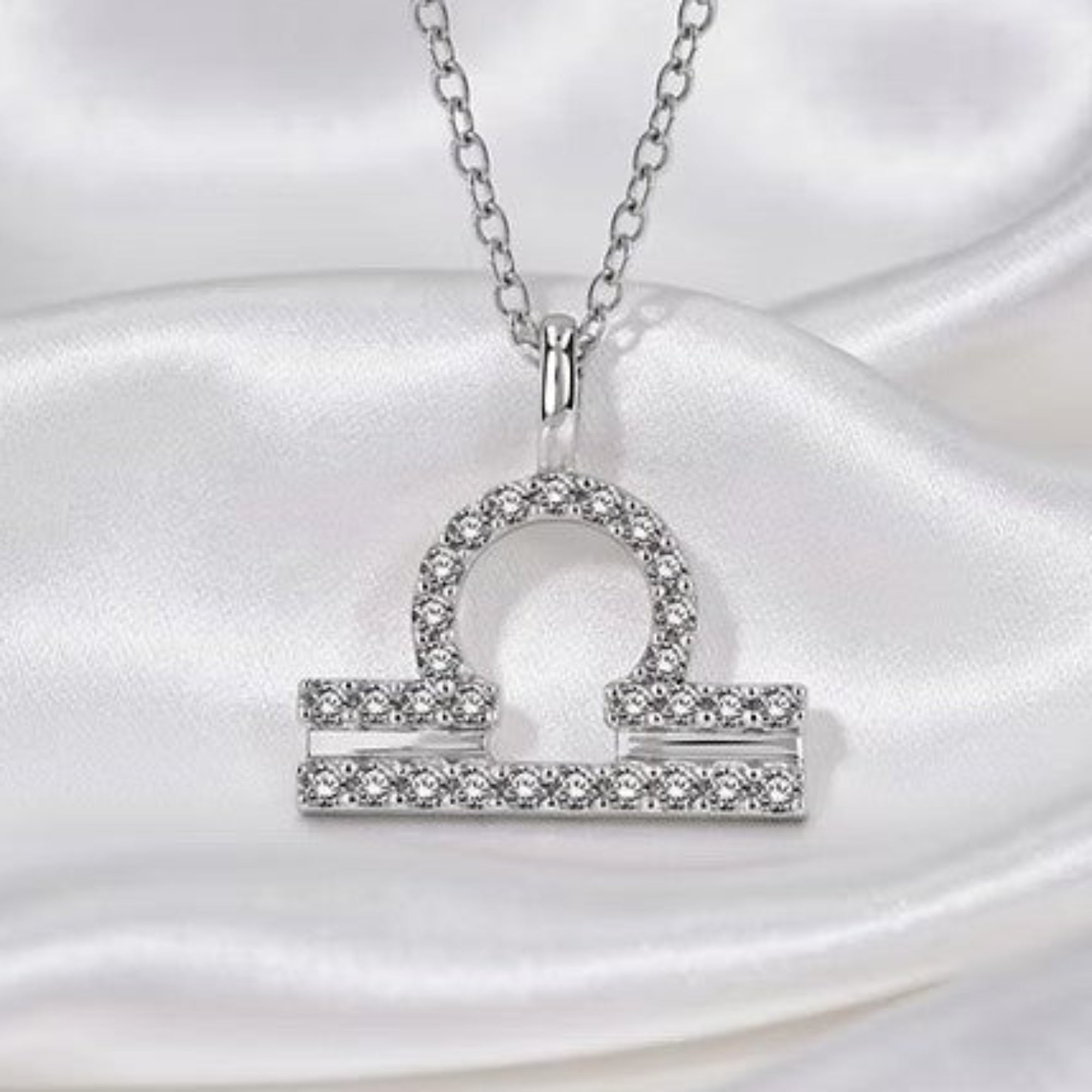 Silver Diamond Zodiac Pendant on Silk White Background