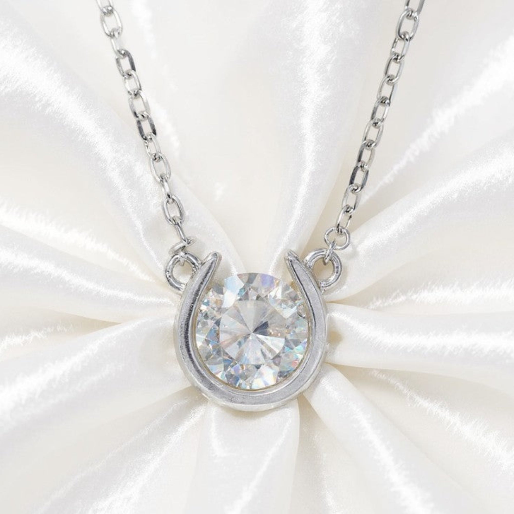 MiraLume Moissanite Diamond Necklace on White Silk Background