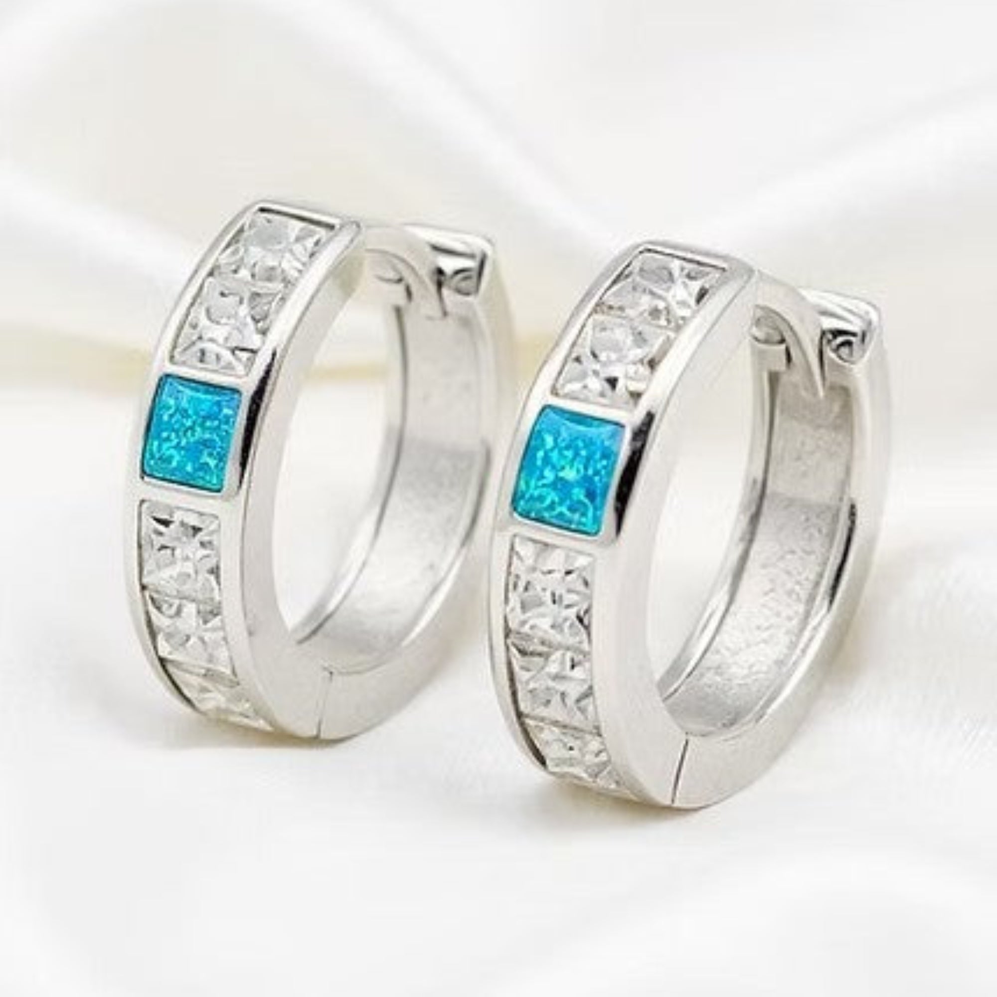 Moissanite Diamond Huggie Earrings with Opal On Silk White Background