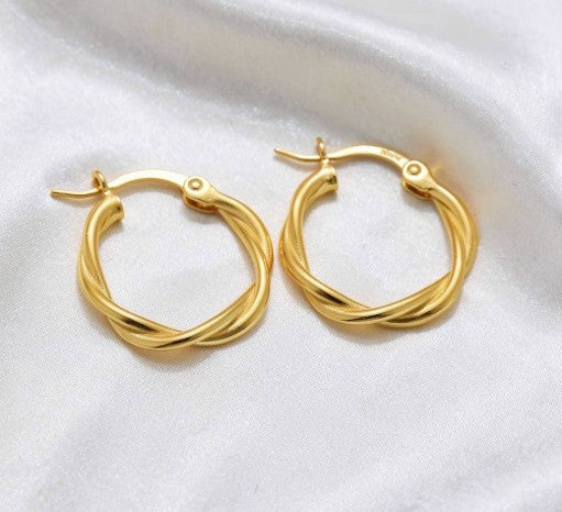 Sterling Silver and Gold Twist Hoop Earrings on Silk White Background