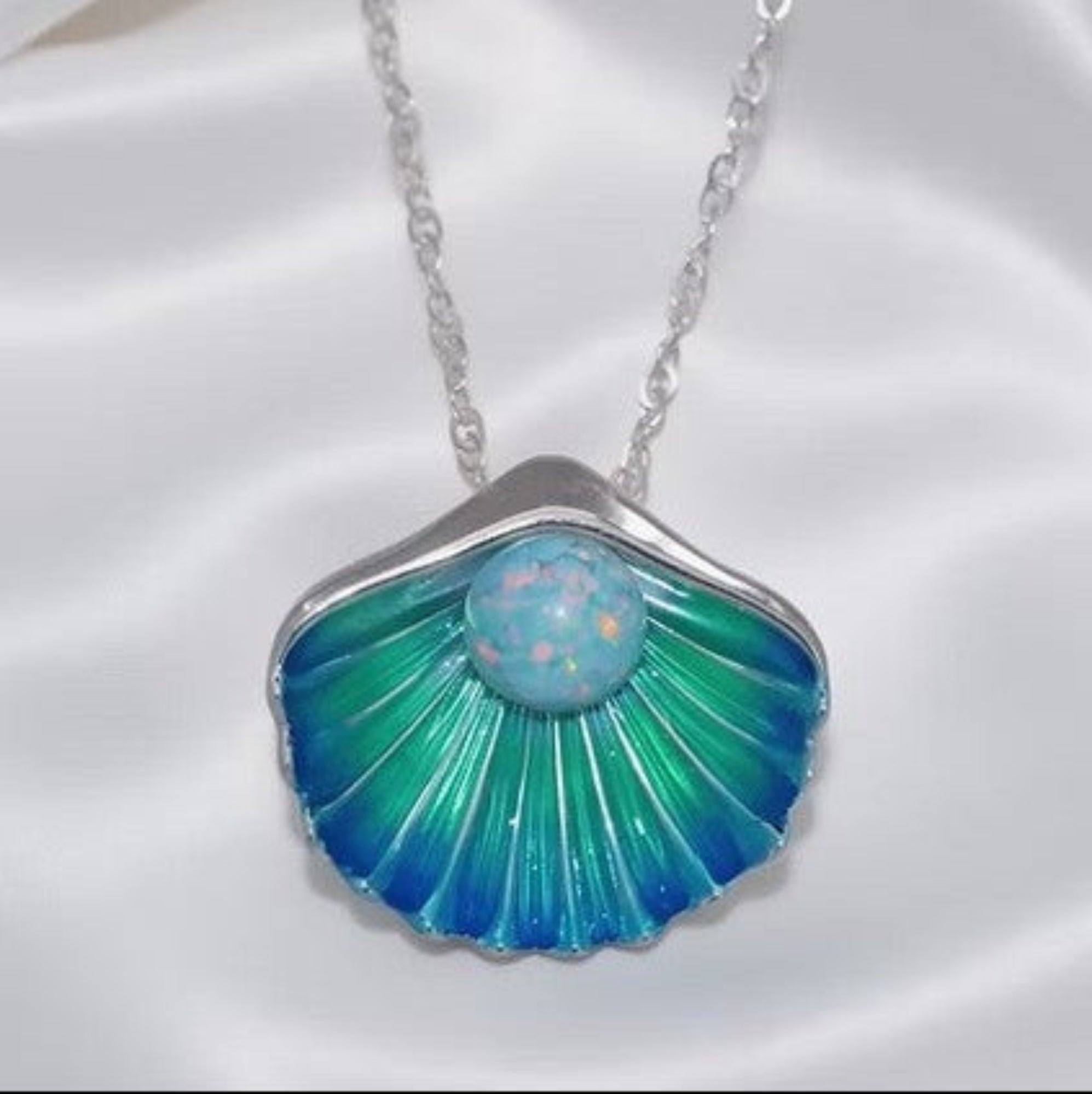 Under The Seashell Opal Pendant .960 Silver on White Silk Background